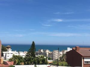 einen Blick auf eine Stadt mit dem Meer im Hintergrund in der Unterkunft Moderno apartamento con piscina disponible según restricciones sequía in Torremolinos