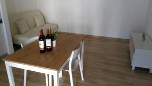 a wooden table with two bottles of wine on it at Archiammare Sea in San Lorenzo