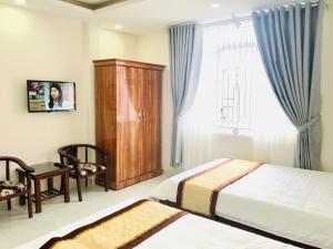 Postel nebo postele na pokoji v ubytování Mai Ngoc Hotel