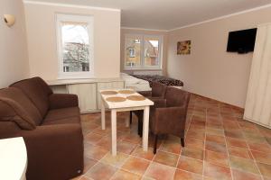 a living room with a couch and a table at Apartamenty Rok in Kołobrzeg