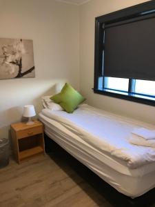 a small bedroom with a bed and a window at Fell Holiday Home in Stapi