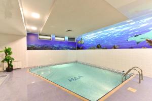 a swimming pool in a room with an aquarium at Hotel Ida in Bansko