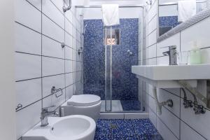 a bathroom with a shower and a toilet and a sink at NaCity Holiday Home in Naples