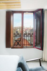 a room with a couch and a window at 7 Gaia Roaster Apartments in Vila Nova de Gaia