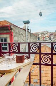 a building with a fence and a clock on it at 7 Gaia Roaster Apartments in Vila Nova de Gaia