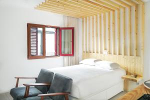 1 dormitorio con 1 cama blanca y 2 sillas en 7 Gaia Roaster Apartments, en Vila Nova de Gaia