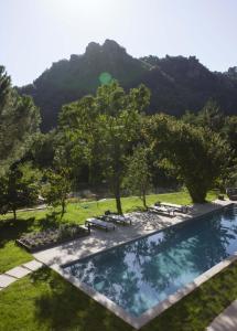 a swimming pool with a mountain in the background at Il Borgo Mediceo in Seravezza