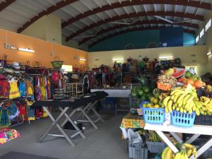 a store with a bunch of fruits and vegetables on display at Superbe appartement T2 résidence sécurisée in Le Diamant