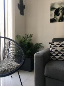 a living room with a chair and a couch at Simons Apartments minutes away from Balluta Bay and St Julians in Sliema