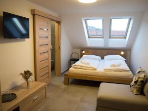 Postel nebo postele na pokoji v ubytování Restaurace - Apartmány Bobule