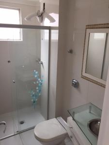 a bathroom with a shower and a toilet and a sink at Apto Central para Família in Balneário Camboriú