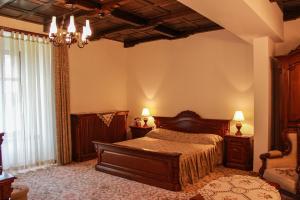 
a bedroom with a large bed and a large window at Hotel Medieval in Alba Iulia
