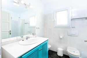 a bathroom with a sink and a toilet and a window at AT Almoraide Rooms Suites in Nerja