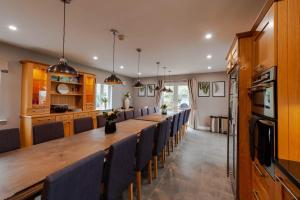 a large dining room with a long table and chairs at Four Winds,Kinsale Town,Exquisite holiday homes,sleeps 26 in Kinsale