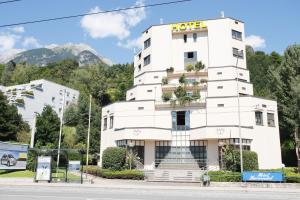 a white building with a hotel sign on it at Sommerhotel Karwendel in Innsbruck