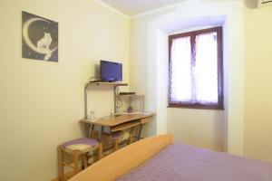 a bedroom with a desk and a bed and a television at Rooms Sara in Grožnjan