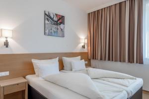 Postel nebo postele na pokoji v ubytování Apart Hotel Garni Wieser