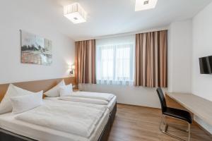 Postel nebo postele na pokoji v ubytování Apart Hotel Garni Wieser