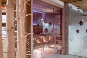 a room with glass doors and a wall with trees at Apart Hotel Garni Wieser in Sölden