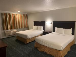 Säng eller sängar i ett rum på Stargazer Inn and Suites