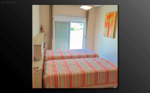 two staircases in a room with a striped cover at Cobertura Praia de Palmas in Governador Celso Ramos