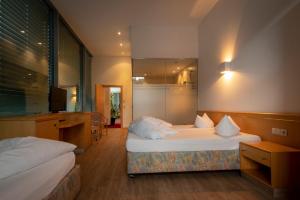Ένα ή περισσότερα κρεβάτια σε δωμάτιο στο Hotel Bruggner Stub`n