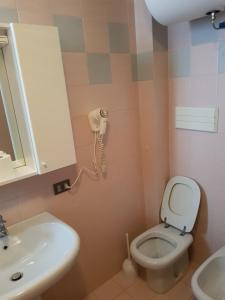 a bathroom with a sink and a toilet and a phone at Appartamento Lorenzoni - Genziana in Croviana