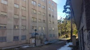 a large building with a gate in front of it at Estudio romántico en Puerto De Navacerrada in Cercedilla