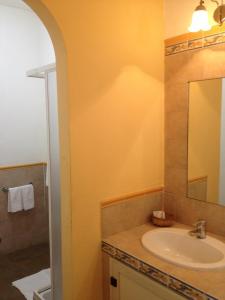 a bathroom with a sink and a mirror at Villa Greta Hotel Rooms & Suites in Taormina
