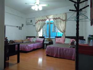 Postel nebo postele na pokoji v ubytování Dai Yi Shia B&B