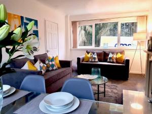 a living room with a couch and a table at South Calder House in Wishaw