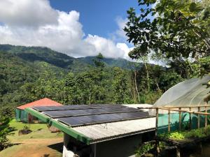 a house with solar panels on top of it at Manoas in Uvita