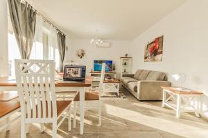 a living room with a table with a laptop on it at Elegant Sophia's Apartment in Braşov