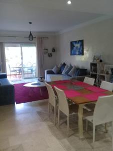 a living room with a table and a couch at Luxury Flat Marina Agadir in Agadir +40 photos