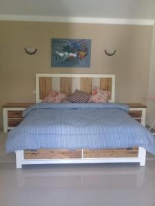 a bed with a blue comforter in a bedroom at Luxury Flat Marina Agadir in Agadir +40 photos