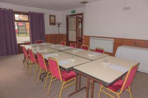 a conference room with a long table and chairs at Primelodge Rotherham in Hellaby