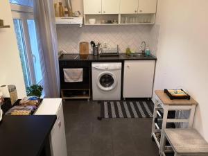a kitchen with a sink and a washing machine at Graf Ignatiev - 3BR APART in Sofia