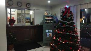 a christmas tree in a room with a store at Valley Hotel in Rosemead