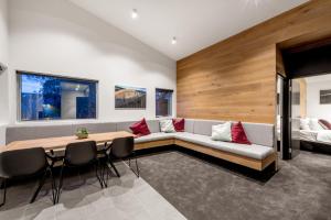 a living room with a couch and a table and chairs at Elk at Falls in Falls Creek