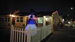 a statue of a man with a top hat on a fence at Valley Hotel in Rosemead