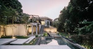 a house with a garden with a pond in the yard at Lloyd's Inn in Singapore