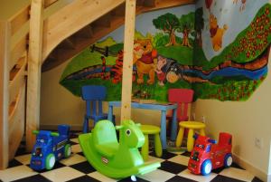a childs play room with toys and a mural at Krzywy Domek w Ostrowie Morza Brzeg in Ostrowo