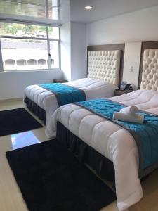Postel nebo postele na pokoji v ubytování Hotel San Antonio Guarne