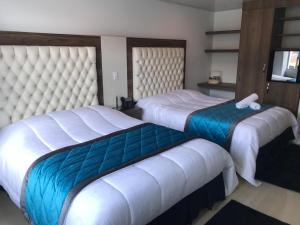 Postel nebo postele na pokoji v ubytování Hotel San Antonio Guarne
