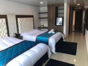Postel nebo postele na pokoji v ubytování Hotel San Antonio Guarne