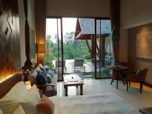 a living room with a couch and a table at Tejaprana Bisma - CHSE Certified in Ubud