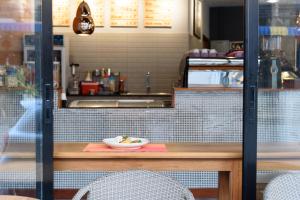 a counter with a bowl of food on a table at Srisuksant Square in Krabi town