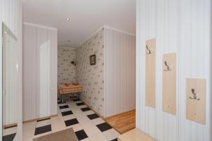 a hallway with white walls and a checkered floor at Amber Coast & Sea in Jūrmala +204 photos