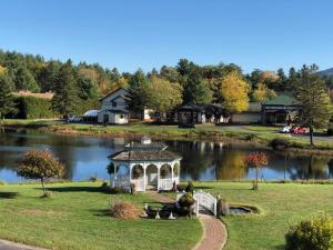 a gazebo in the middle of a lake at Sara Placid Inn & Suites in Saranac Lake