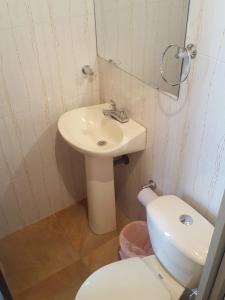 a bathroom with a white sink and a toilet at Hotel San Agustín in San Agustín